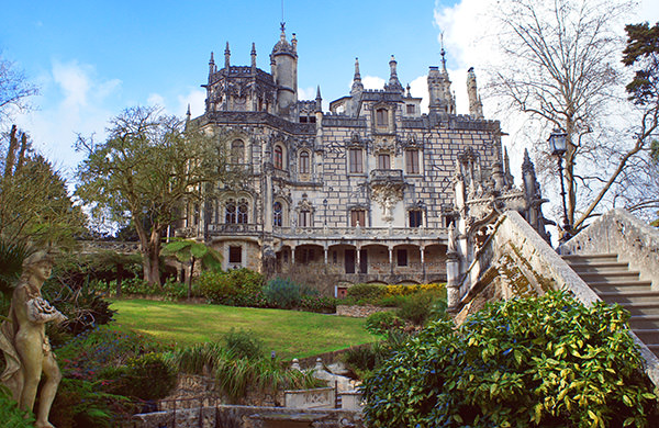 Sintra, Portugal - February 12, 2015: Quinta da Regaleira mansion, World Heritage Site by UNESCO and one of the principal tourist attractions of Sintra, in spring sunny day.