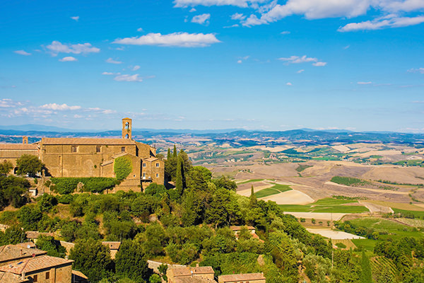 Residential buildings and a church in the historic medieval village of Montalcino in Siena province, Tuscany, Italy